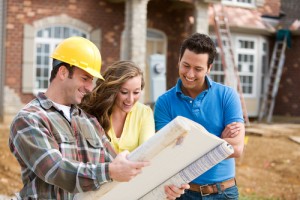 Couple and builder looking at plans