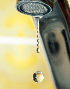 Water droplet falling from faucet