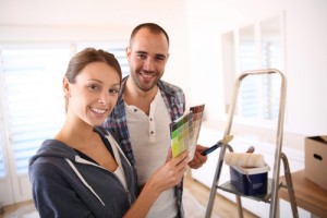 Young couple painting home
