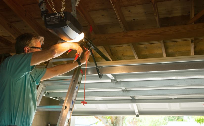 man installing garage door