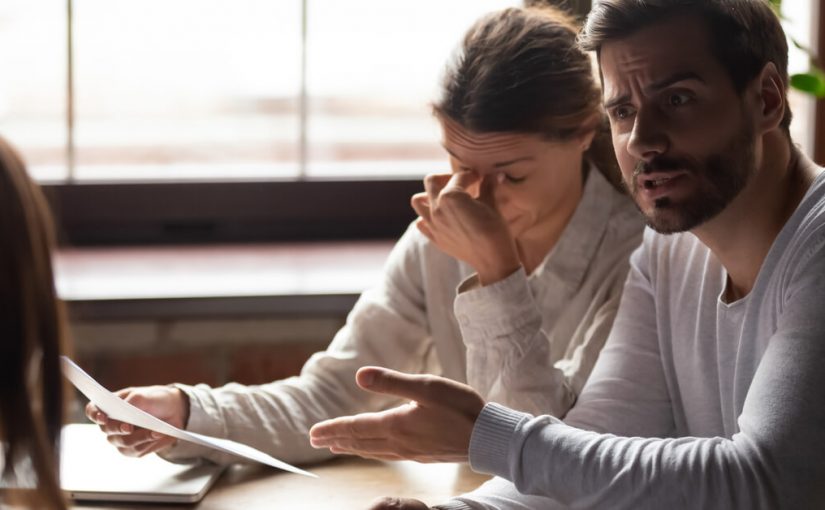 outraged man and annoyed woman discuss agreement